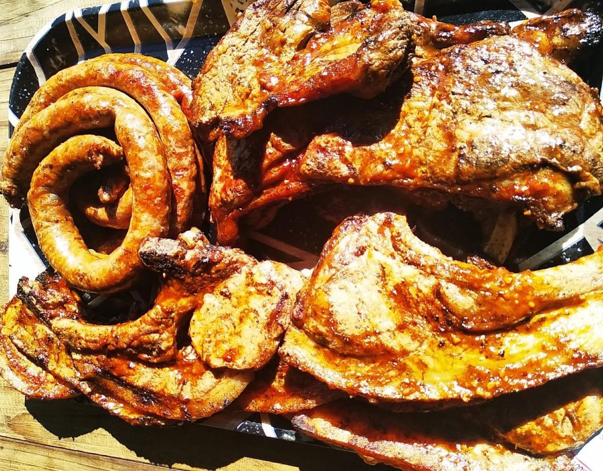 Braai platter of chops, steak and sausage on a tray
